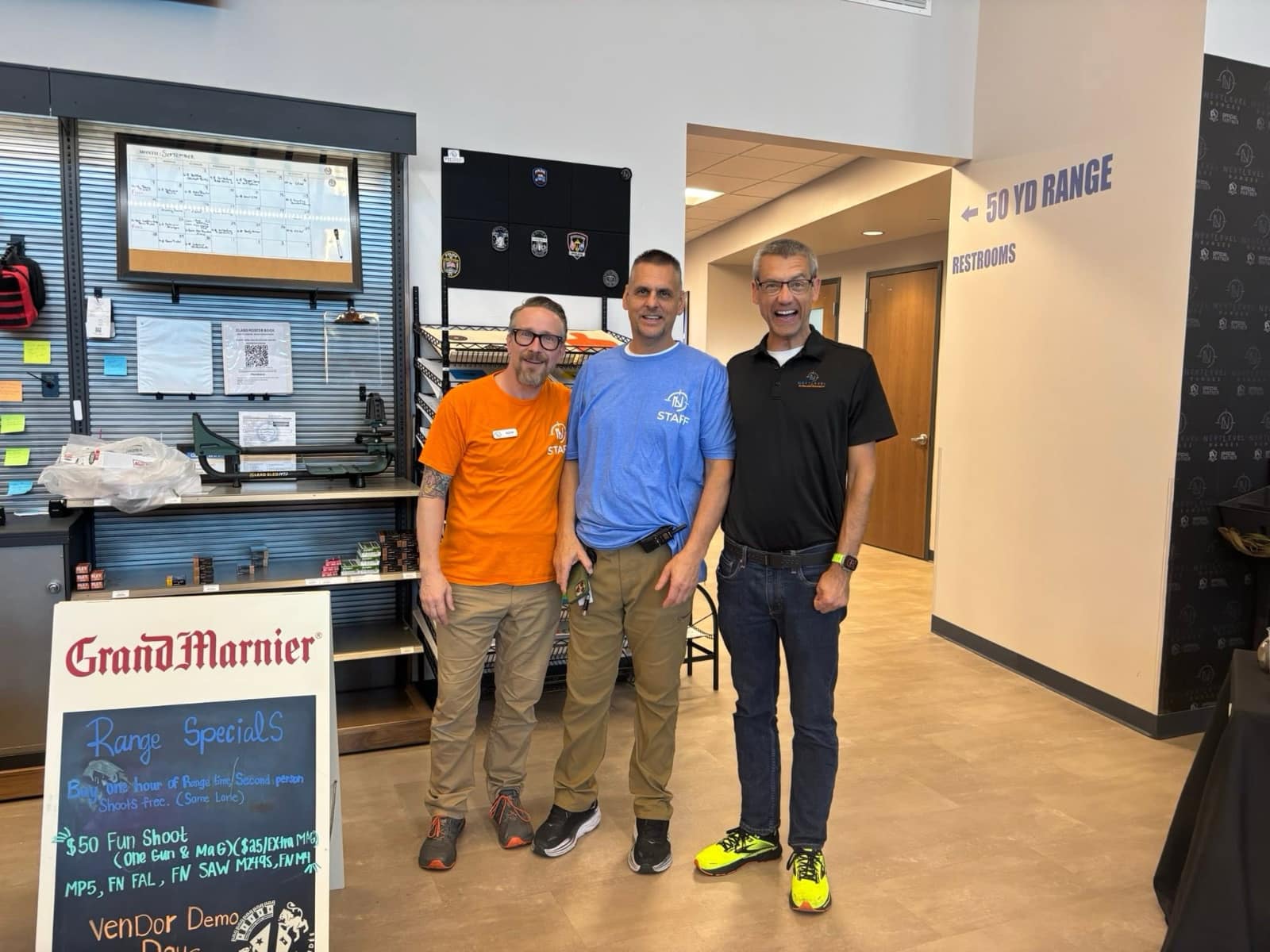 Next Level Ranges staff and a Vendor Demo Day representative inside the range