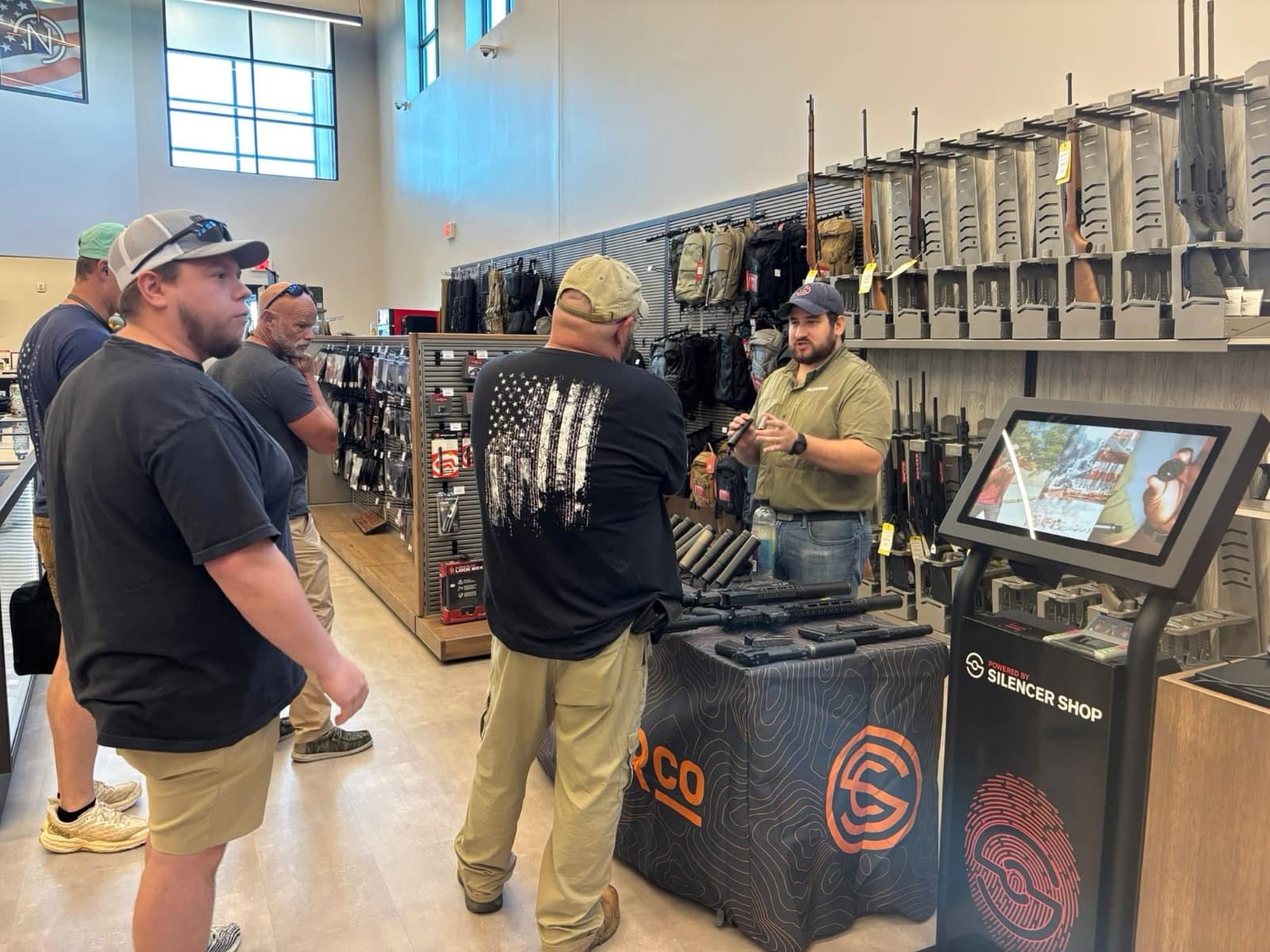 Attendees speaking with firearm-industry representatives during a previous Vendor Demo Day at Next Level Ranges