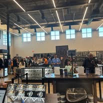 Vendor Demo Day booths and attendees inside Next Level Ranges
