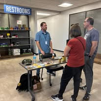 Attendees speaking with a vendor representative at Vendor Demo Day