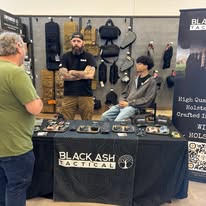 Attendee viewing a Black Ash Guns vendor display